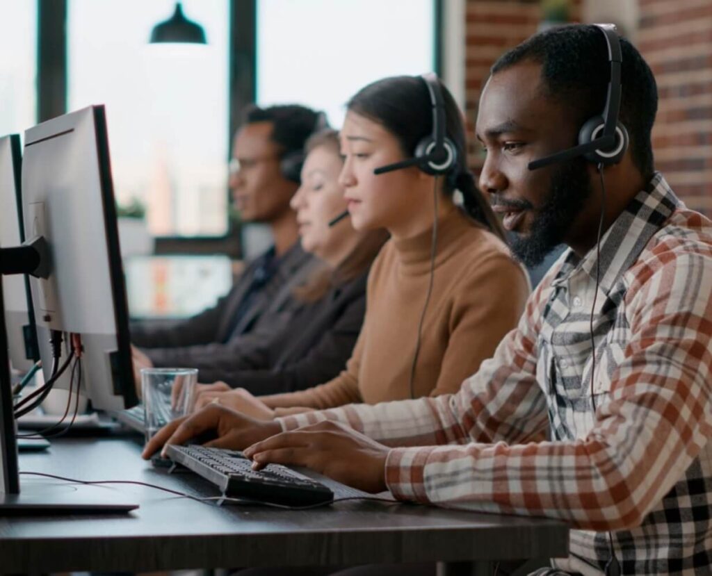 3 Workers in Contact Center Speaking to Clients 845x684 1